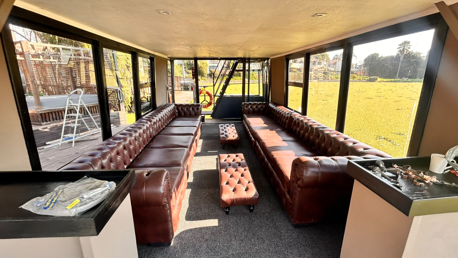 The cabin aboard the Nova Lounge, looking out over Hartbeespoort Dam